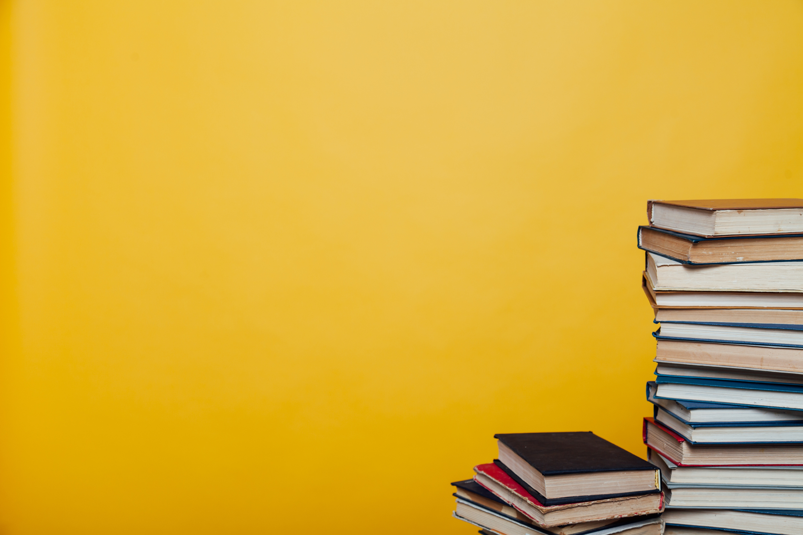 stacks of educational books university library background
